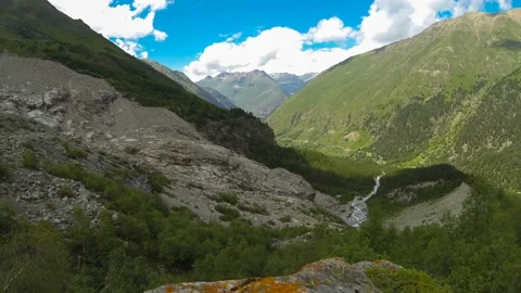 Movement of clouds and water flows in a stormy river in the Caucasus mountains Stock Footage 87617760