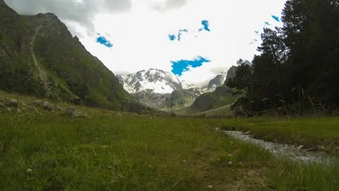 Movement of clouds and water flows in a stormy river in the Caucasus mountains Stock Footage 87618132