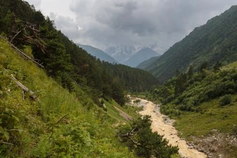 Movement of clouds and water flows in a stormy river in the Caucasus mountain Stock Photos
