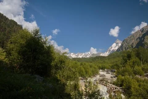 Movement of clouds and water flows in a stormy river in the Caucasus mountain Stock Photos