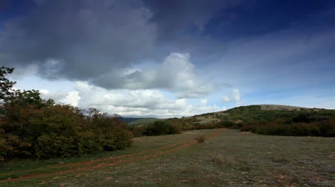 Movement of the clouds on the mountain on a dirt road. Crimea,  Video stock 32007735