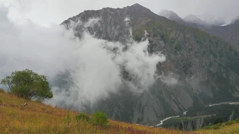 The movement of clouds in a mountain valley Stock Footage 129070515