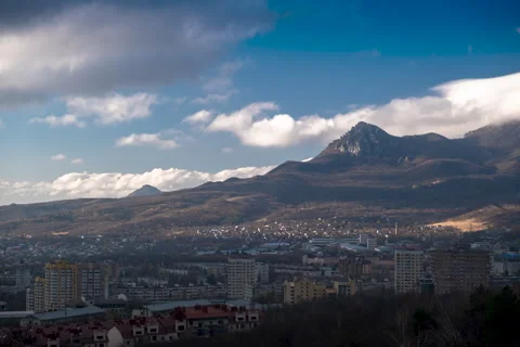 Movement of clouds over the city and mountain peaks Stock Footage 306302065