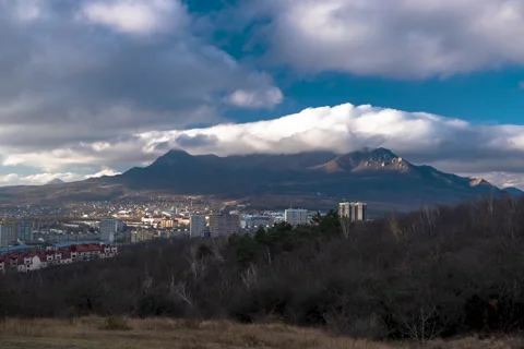 Movement of clouds over the city and mountain peaks Stock Footage 306302118
