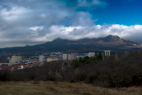 Movement of clouds over the city and mountain peaks Stock Footage 306302250