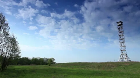 Movement of clouds over a field and an observation tower (timelapse) Stock Footage 23542597