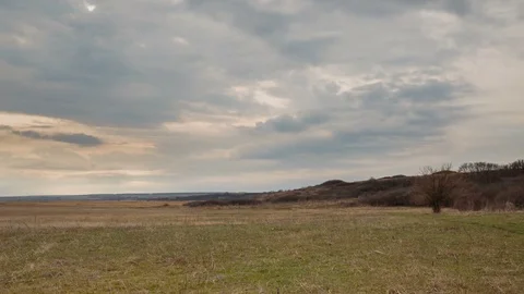 The movement of the clouds over the fields of winter wheat in spring in steppes Stock Footage 73938428