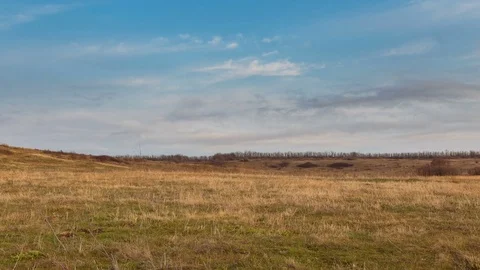The movement of the clouds over the fields of winter wheat in spring in steppes Stock Footage 73939576