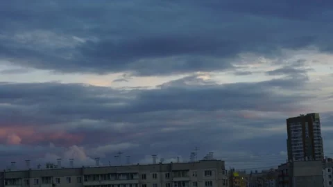 The movement of clouds over houses in the evening in the city Stock Footage 201503576