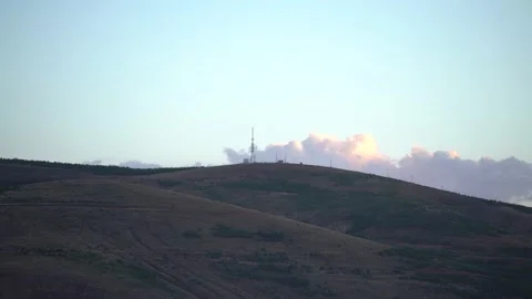 The movement of clouds over a mountain full of brownness and in the open sky Stock Footage 142968719