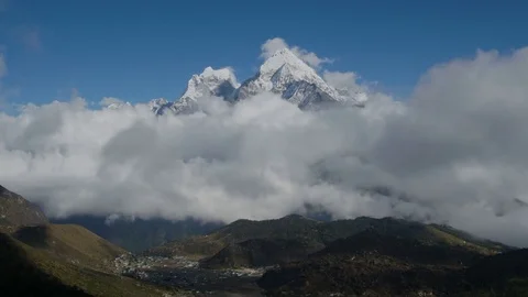 The movement of clouds over the mountain Kangtega Stock Footage 82816681