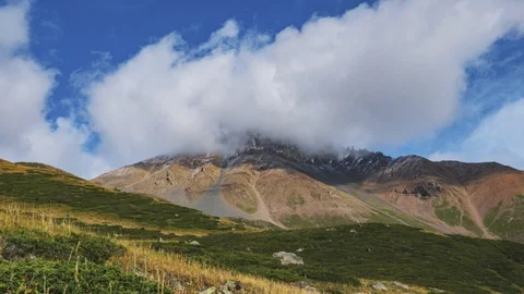 The movement of clouds over a mountain peak Stock Footage 129070669