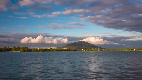 The movement of clouds over a mountain peak and lake Stock Footage 151424547