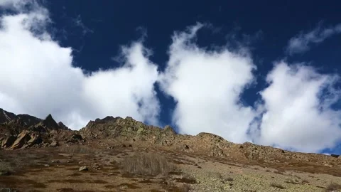 The movement of clouds over mountain rocks. Stock Footage 158459408