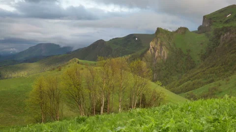 Movement of clouds over the summer slopes of Caucasus Mountains 動画素材 67251919