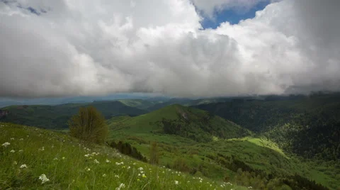 Movement of clouds over the summer slopes of Caucasus Mountains 動画素材 67254326