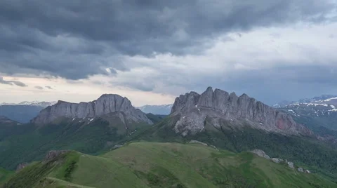 Movement of clouds over the summer slopes of Caucasus Mountains Stock Footage 67307409