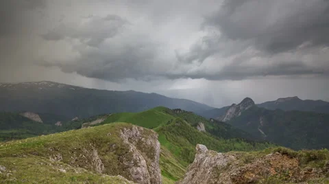 Movement of clouds over the summer slopes of Caucasus Mountains Stock Footage 67308008