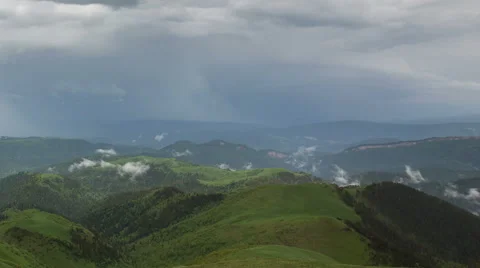 Movement of clouds over the summer slopes of Caucasus Mountains Stock Footage 67308133
