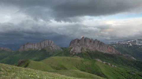 Movement of clouds over the summer slopes of Caucasus Mountains Stock Footage 67329897