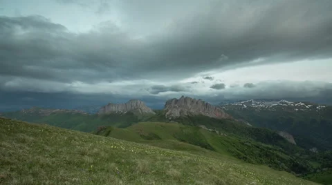 Movement of clouds over the summer slopes of Caucasus Mountains Stock Footage 67333445