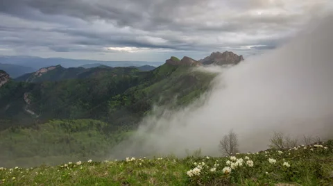 Movement of clouds over the summer slopes of Caucasus Mountains Stock Footage 67334439