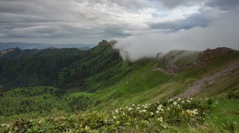Movement of clouds over the summer slopes of Caucasus Mountains Stock Footage 67334531