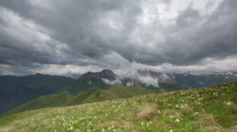 Movement of clouds over the summer slopes of Caucasus Mountains Stock Footage 67335074