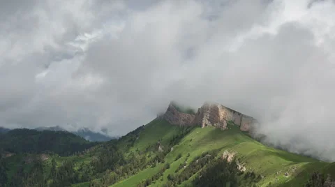 Movement of clouds over the summer slopes of Caucasus Mountains Stock Footage 67344372