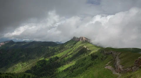 Movement of clouds over the summer slopes of Caucasus Mountains Stock Footage 67344707