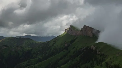 Movement of clouds over the summer slopes of Caucasus Mountains Stock Footage 67344831