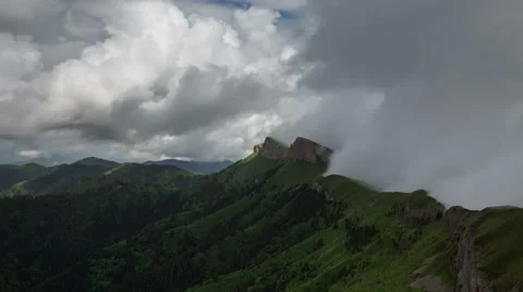 Movement of clouds over the summer slopes of Caucasus Mountains Stock Footage 67345011