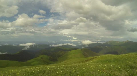 Movement of clouds over the summer slopes of Caucasus Mountains Stock Footage 67345244