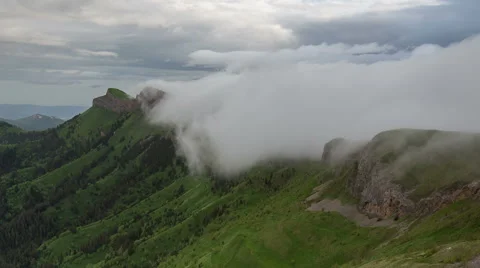 Movement of clouds over the summer slopes of Caucasus Mountains Stock Footage 67345499