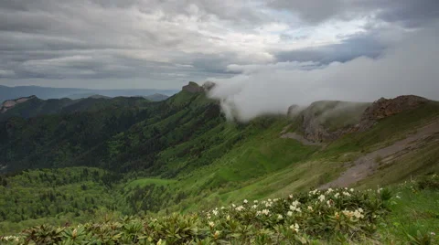 Movement of clouds over the summer slopes of Caucasus Mountains Stock Footage 67345762