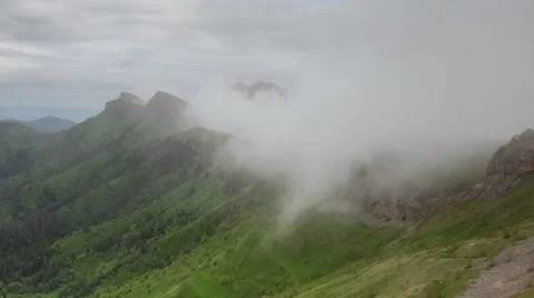 Movement of clouds over the summer slopes of Caucasus Mountains Stock Footage 67345884
