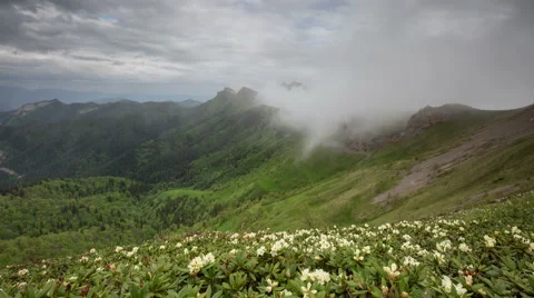 Movement of clouds over the summer slopes of Caucasus Mountains Stock Footage 67346439