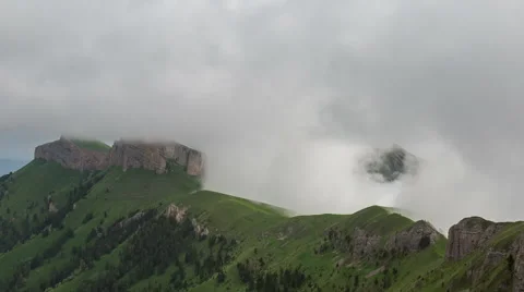 Movement of clouds over the summer slopes of Caucasus Mountains Stock Footage 67346586