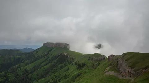 Movement of clouds over the summer slopes of Caucasus Mountains Stock Footage 67346743