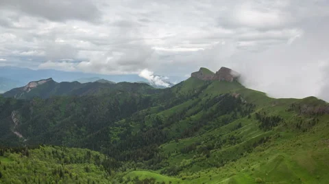 Movement of clouds over the summer slopes of Caucasus Mountains Stock Footage 67346853