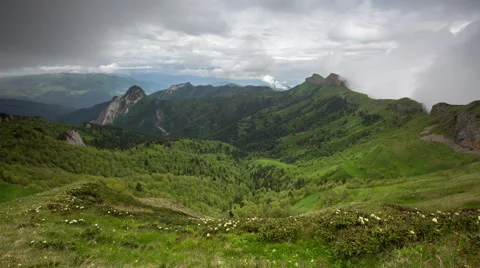 Movement of clouds over the summer slopes of Caucasus Mountains Stock Footage 67347249