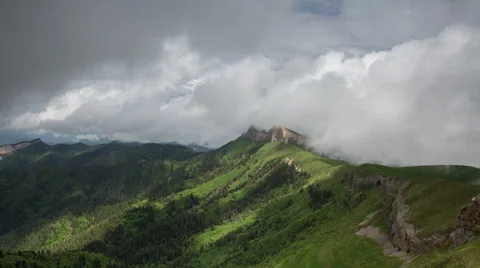 Movement of clouds over the summer slopes of Caucasus Mountains Stock Footage 67347289
