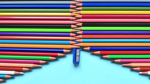The movement of colored pencils on a blue background. Stock Footage