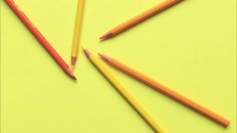 The movement of colored pencils on a yellow background. Video stock 159847148