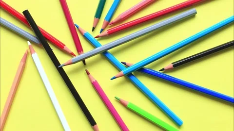 The movement of colored pencils on a yellow background. Video stock 160521337