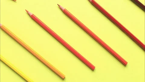 The movement of colored pencils on a yellow background. Video stock 160953925