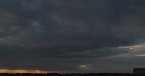 Movement of dark clouds during sunset with sunlights breaking through Stock Footage 252940363