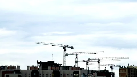 The movement of dark clouds over the cranes and construction site Stock-Footage 79462266