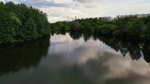 Movement of the drone along the bed of a wide river on both sides covered with Stock Footage 159828135