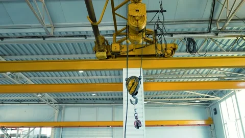 Movement of an electric crane along the guide rails under the ceiling Stock Footage 228304150